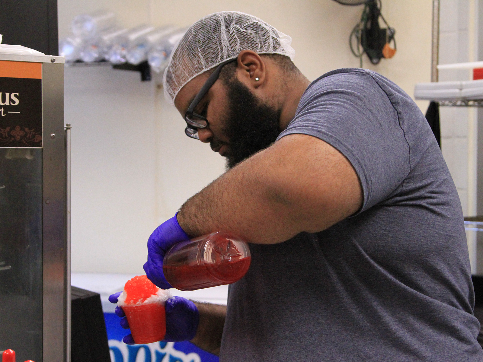 Cafe employee making sno cone