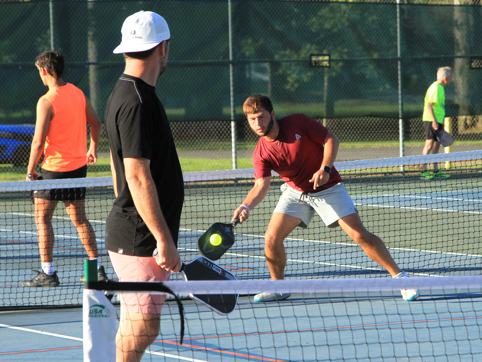 pickleball player hitting ball