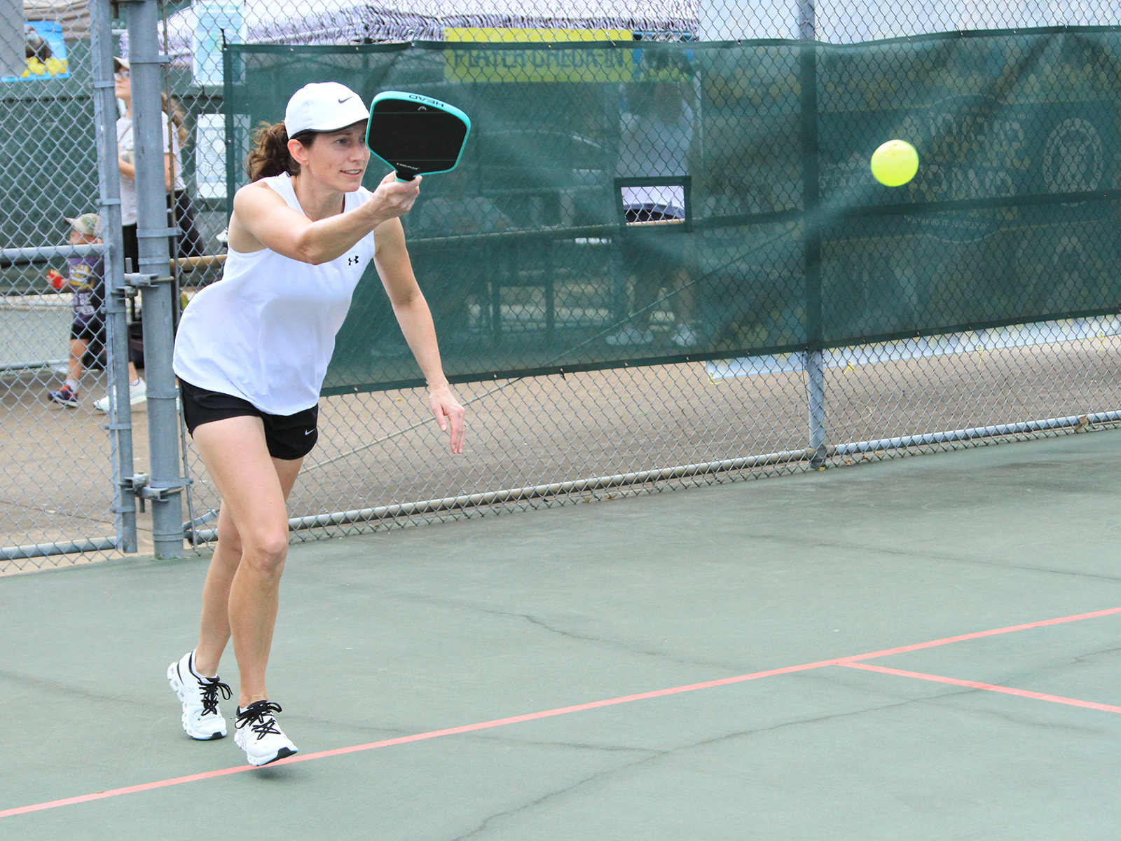 female pickleball player hitting ball