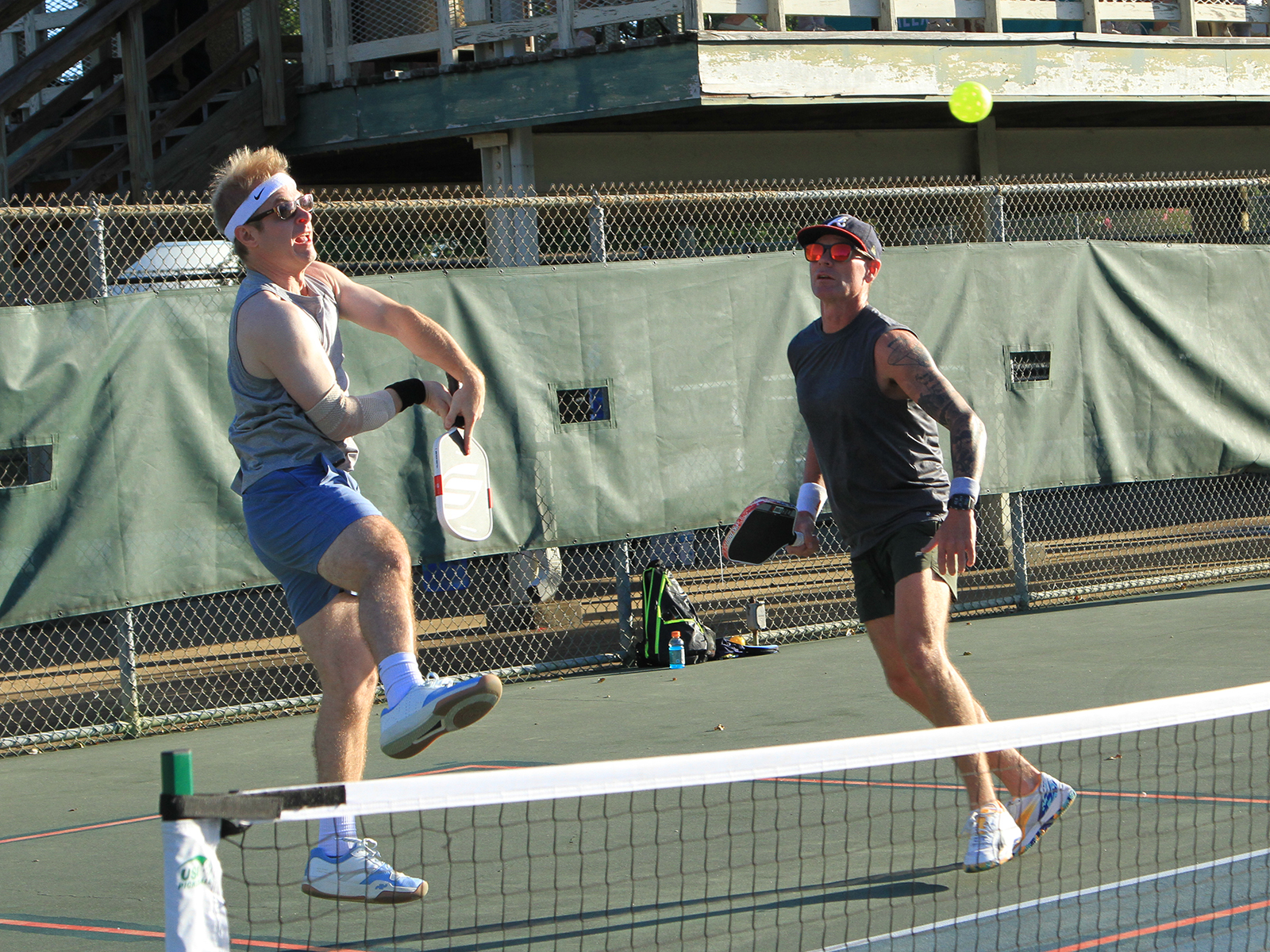 male pickleball player hitting ball