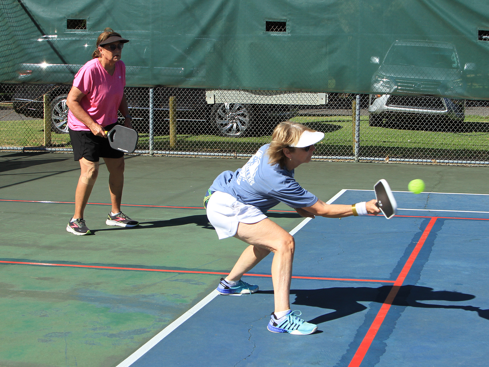 female pickleball player hitting ball